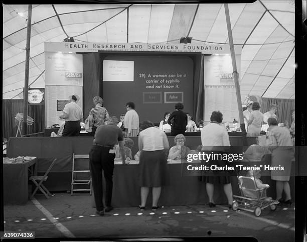 View of Health Research and Services Foundation booth with quiz about syphilis at United Fund's Health-O-Rama tent at Homestead, circa 1966.