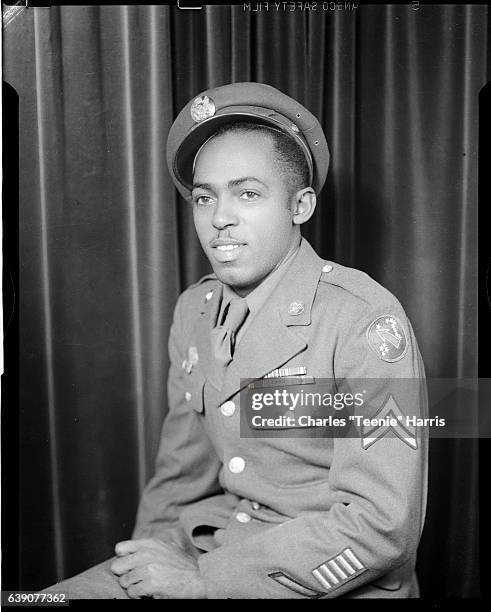 Portrait of man wearing U.S. Army uniform with Corporal chevron patch on sleeve, U.S. Army Pacific patch on shoulder, Quartermaster Corps insignia on...