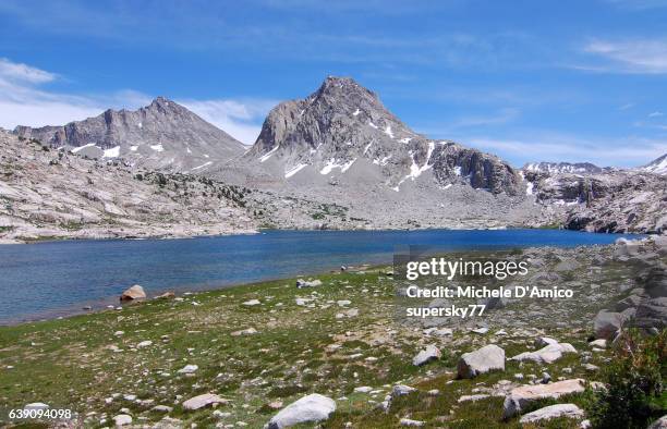 blue alpine lake surrounded by granite peaks - sapphire stock pictures, royalty-free photos & images