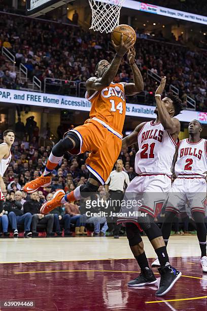 DeAndre Liggins of the Cleveland Cavaliers shoots over Jimmy Butler of the Chicago Bulls during the first half at Quicken Loans Arena on January 4,...