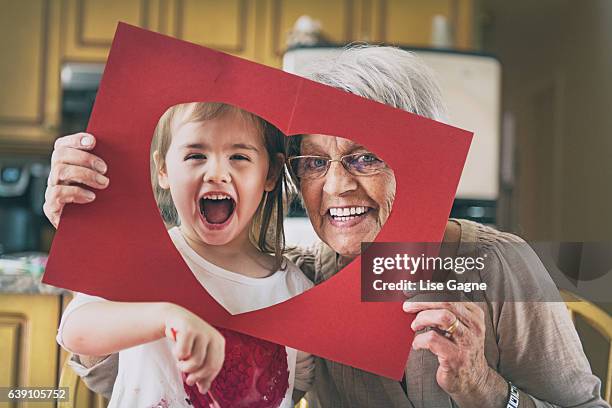 little girl doing bricolage with grandmother - menina fantasia bonita imagens e fotografias de stock