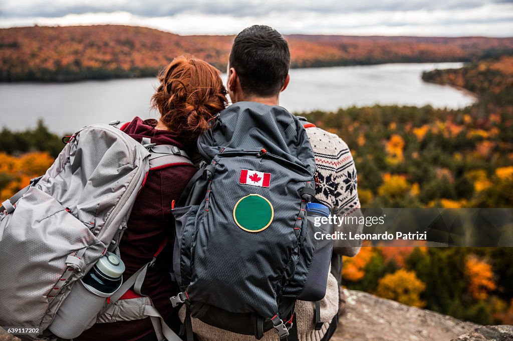 Young couple hiking in mountain and relaxing looking at view