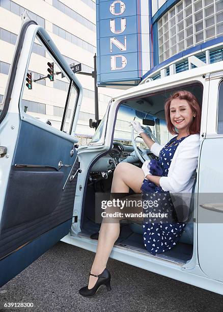 flirtatious young woman in vintage car - lady greyhound stock pictures, royalty-free photos & images