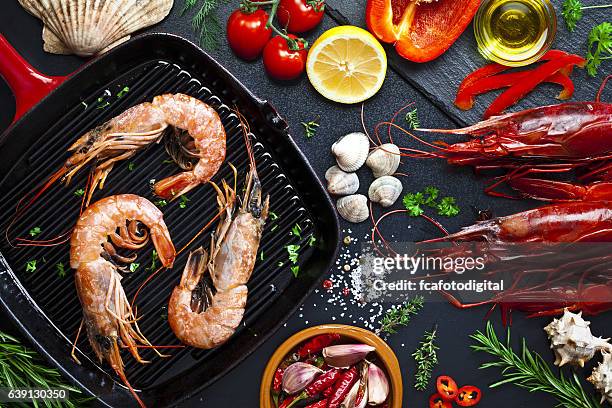 cooking shrimps in a grill - bbq shrimp stock pictures, royalty-free photos & images