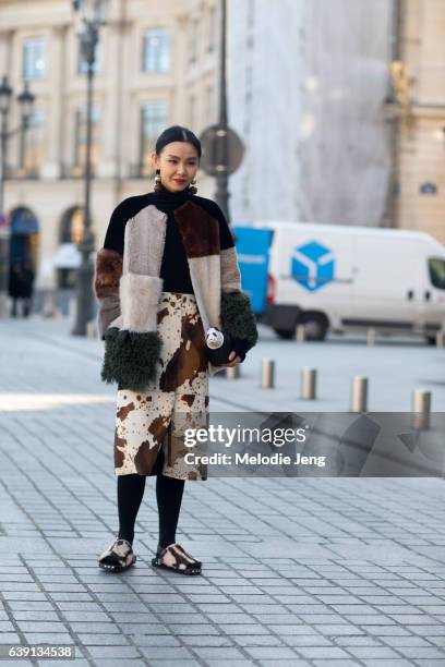 Sherry Shen wears Marni and carries a Loewe panda coin purse outside the Balenciaga show at Place Vendome on January 18, 2017 in Paris, France.