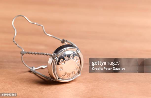 champagne muselet on wooden background - champagne cork stock pictures, royalty-free photos & images