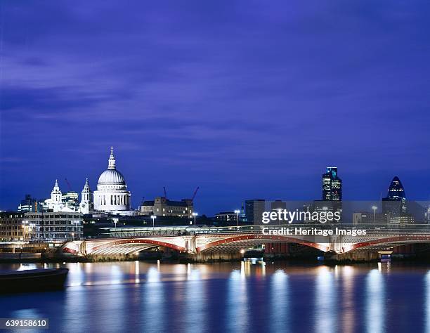 Blackfriars Bridge, London, c1990-2010. Urban landscape of River Thames, St Paul's, Swiss Re building etc. At night. Blackfriars Bridge is a road and...