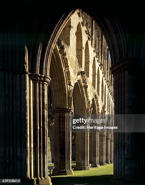 Rievaulx Abbey, North Yorkshire, c1990-2010. View through silhouetted arch to Presbytery arcade looking North East. A former Cistercian abbey in the...