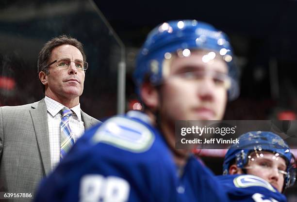 Assistant coach Doug Lidster of the Vancouver Canucks looks on from the bench during their NHL game against the New Jersey Devils at Rogers Arena...