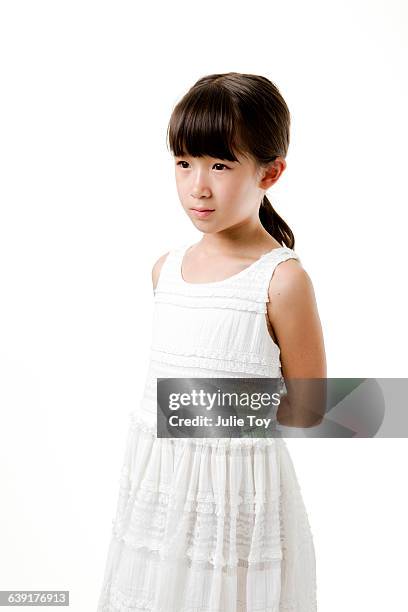 little girl in white dress - sad girl standing stock pictures, royalty-free photos & images