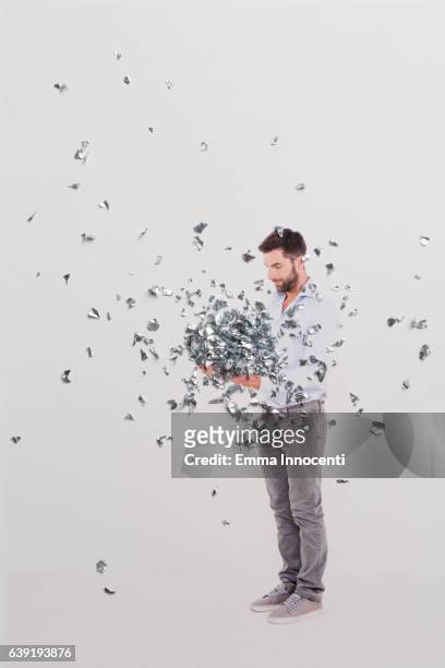 young man looking down at metal shavings - shavings stock pictures, royalty-free photos & images