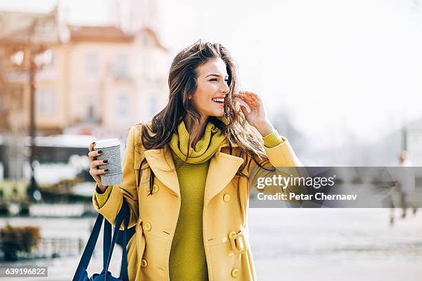 beautiful woman walking outdoors on a sunny day - beautiful woman walking stock pictures, royalty-free photos & images