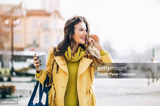 beautiful woman walking outdoors on a sunny day - a fall from grace 個照片及圖片檔