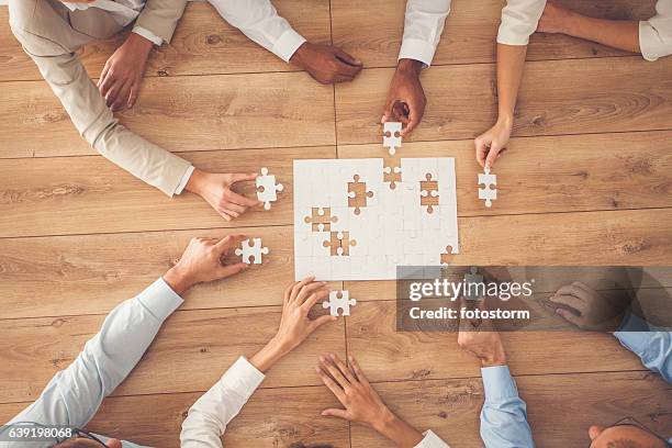 business people finding solution together at office - togetherness hands stock pictures, royalty-free photos & images