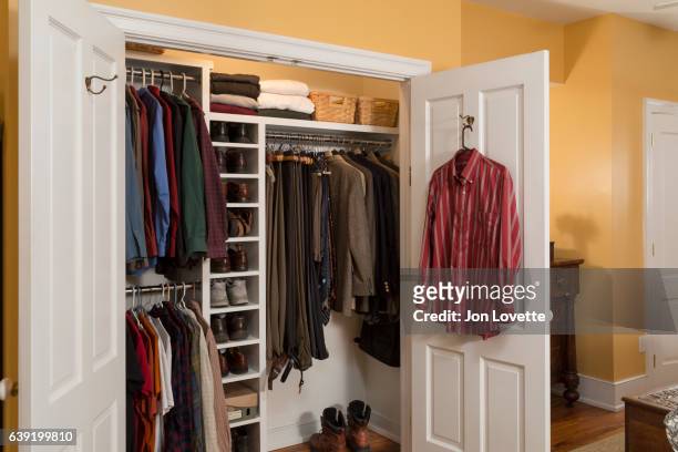 closet in home with mens clothes arranged neat - placard fotografías e imágenes de stock