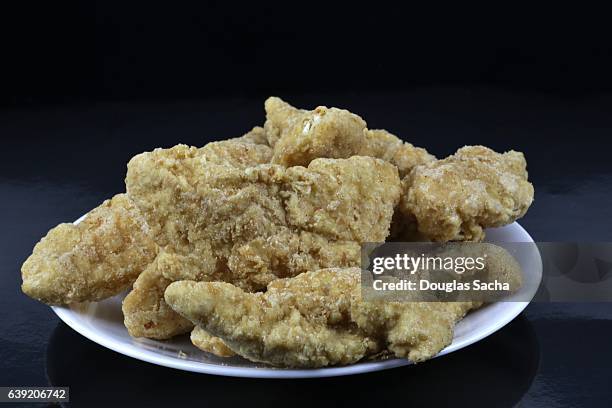 frozen chicken fillets on a serving dish - fish nuggets stock pictures, royalty-free photos & images