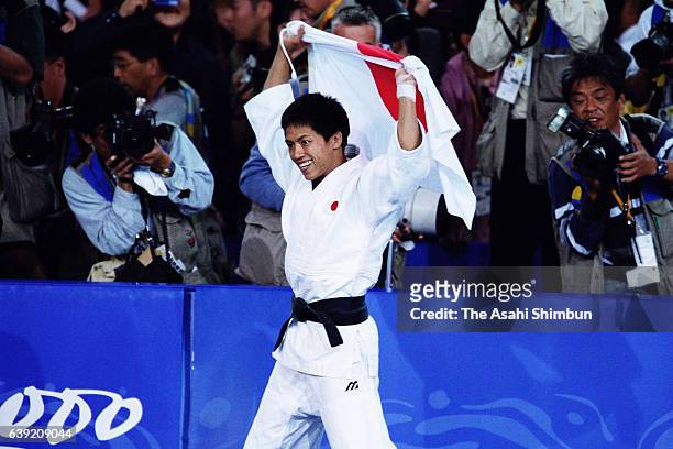 Tadahiro Nomura of Japan celebrates winning the gold medal after winning the Men's Judo -60kg gold medal match against Jung Bu-kyung of South Korea...