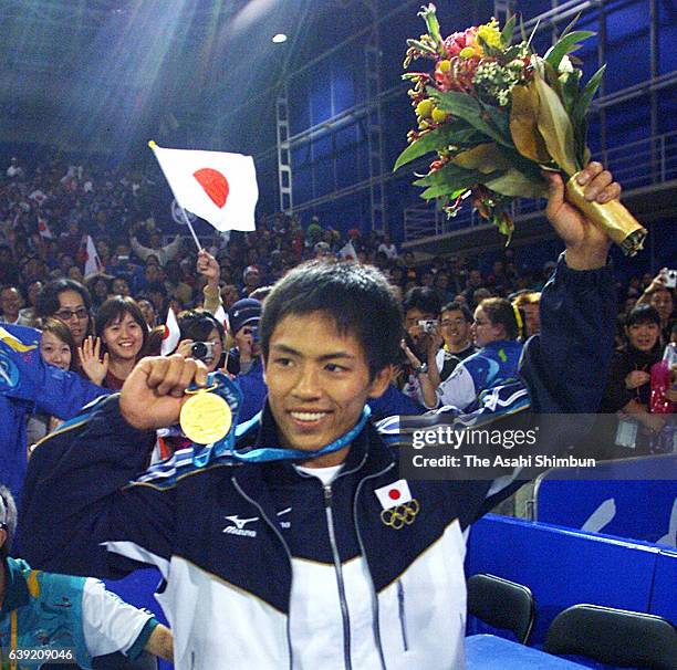 Gold medalist Tadahiro Nomura of Japan celebrates after the medal ceremony for the Men's Judo -60kg during the Sydney Olympics at the Sydney...