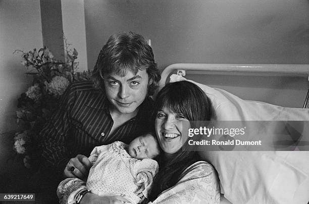 Welsh actor Hywel Bennett with his wife, journalist and broadcaster Cathy McGowan and their newborn baby Emma, UK, 24th May 1971.