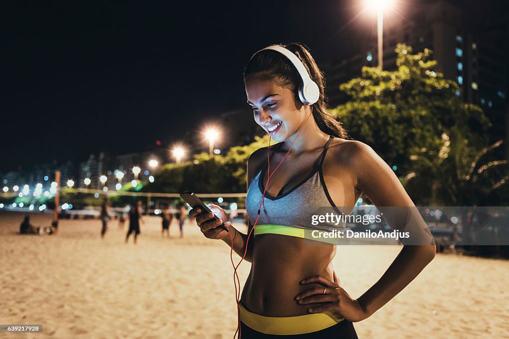 Jogger using her smartphone and resting