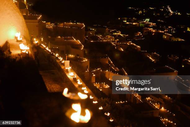 pyrgos, a village in santorini island illuminated during easter by 10000 cans lit with fire - greek easter stock-fotos und bilder