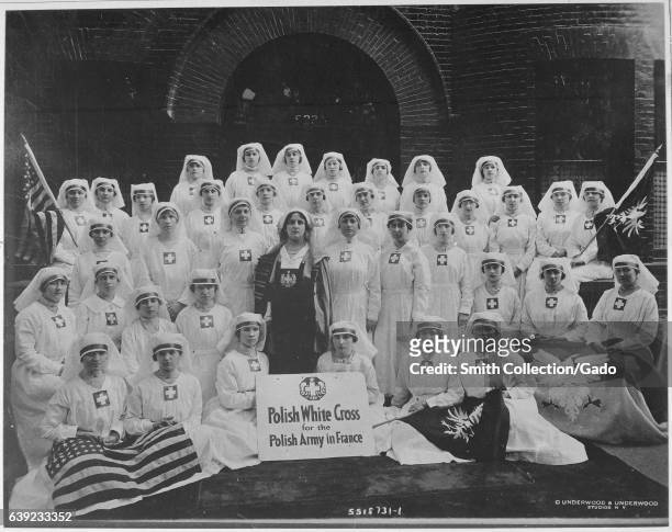 Thirty seven Polish nurses assisting the Polish Army in France during World War I, wearing white gowns and habits and posing together as a group, New...