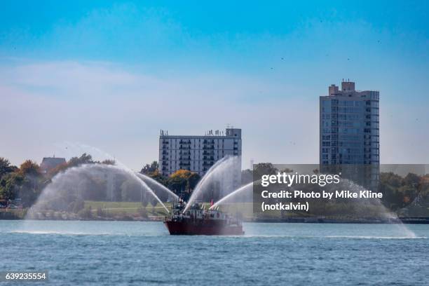 fireboat on the detroit river - detroit river fotografías e imágenes de stock