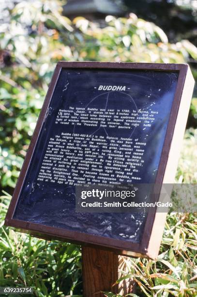 Signage for a Buddha statue in the Hagiwara Japanese Tea Garden, Golden Gate Park, San Francisco, California, 1978. .