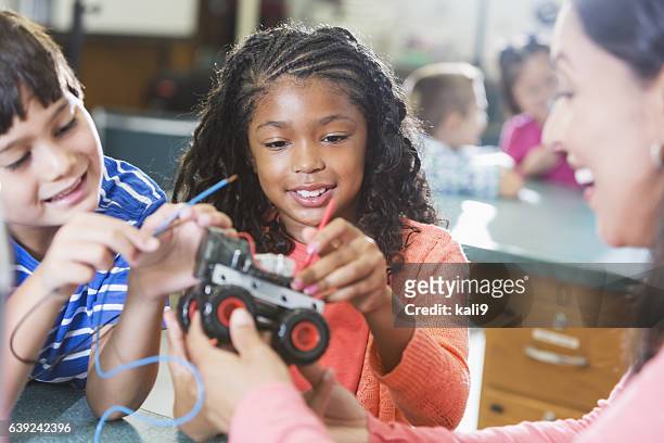 black girl in science class learning robotics - preteen girl models stock pictures, royalty-free photos & images