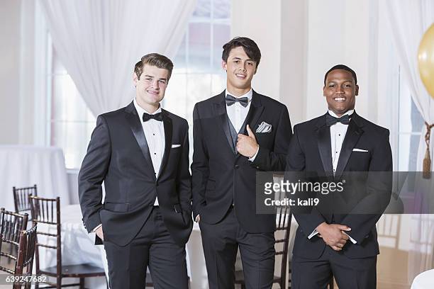 drei junge männer tragen smokings - tuxedo stock-fotos und bilder