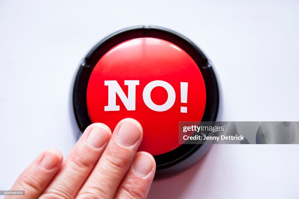 Woman pressing a button that says NO!