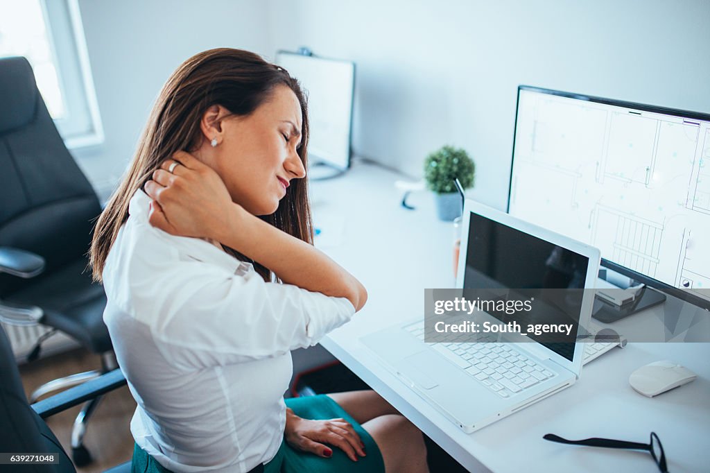Young Businesswoman Suffering From Neckache