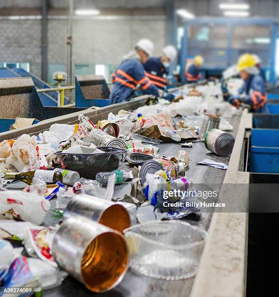 garbage on a conveyor belt for recycling - centro di riciclaggio foto e immagini stock