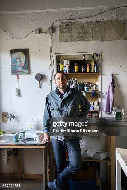 portrait of artist standing in atelier - atelier stock pictures, royalty-free photos & images