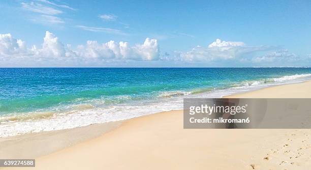 waves crashing at the beach - praia de faro, faro, portugal - high tide stock pictures, royalty-free photos & images