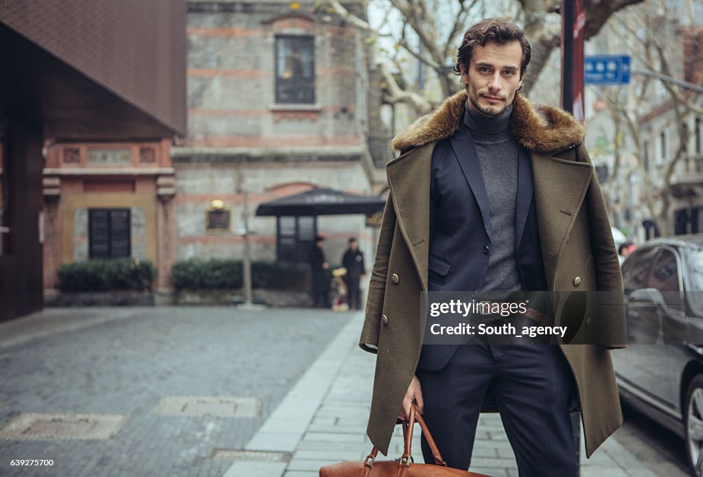 Elegant man with a travel bag