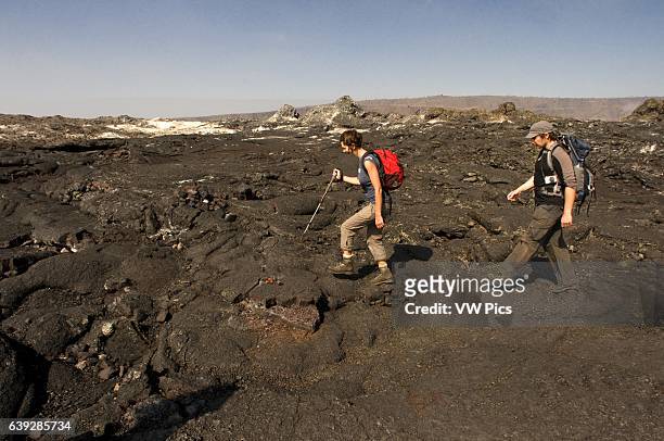 Tourists in Hawai'i Volcanoes National Park. Big Island. Hawaii. USA. Halema_uma_u crater is a pit crater located within the much larger summit...