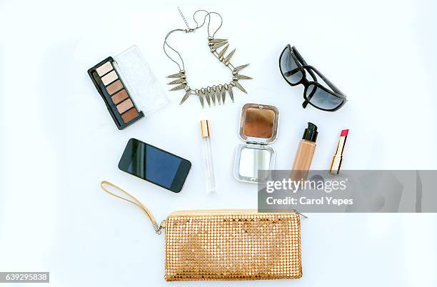 dressing case with a lot of feminine objects.yellow background - yellow purse foto e immagini stock