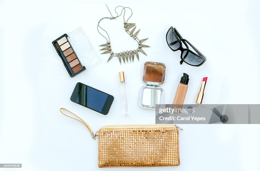 Dressing case with a lot of feminine objects.yellow background