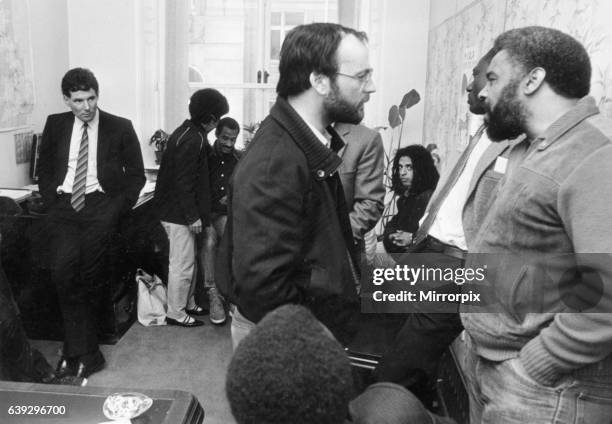 Derek Hatton looks on as he is imprisoned in his council office by members of the Black Caucus along with Tony Mulhearn and Sam Bond, and told...