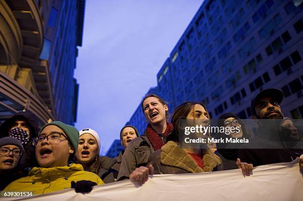 Protestors demonstrate at dawn near the National Mall before the inauguration of Donald Trump as the 45th President of the United States January 20,...