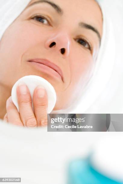 woman cleaning face with cotton wool - cotton pad stock pictures, royalty-free photos & images