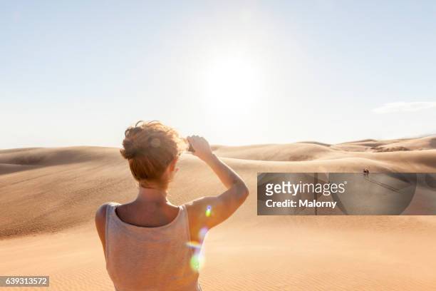 sand dunes, woman taking pictures with her smartphone - hot vietnamese women stock pictures, royalty-free photos & images