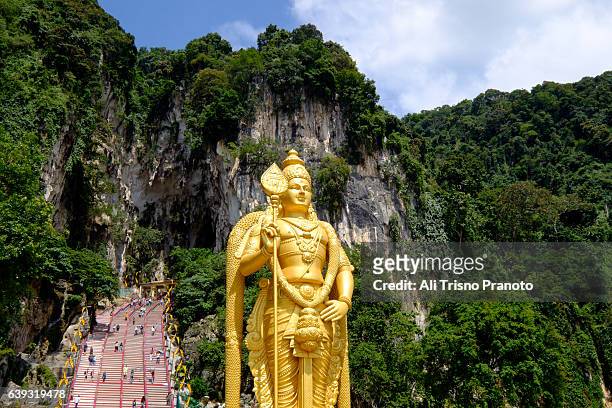 lord murugan statue in batu caves, kuala lumpur, malaysia. - batu caves stock pictures, royalty-free photos & images