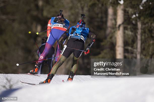 Tim Burke of the United States of America is chased by Simon Schempp of Germany during the 20 km men's Individual on January 20, 2017 in...