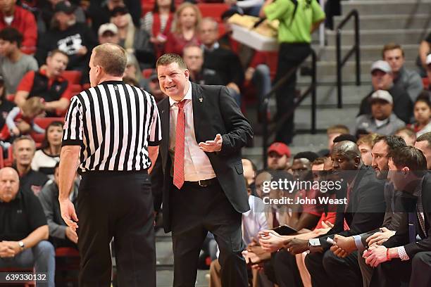 Head coach Chris Beard of the Texas Tech Red Raiders debates a call with NCAA official Gerry Pollard during the game against the TCU Horned Frogs on...