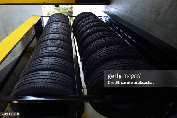 tire rubber products , group of new tires for sale at a tire store. - burning rubber stock pictures, royalty-free photos & images