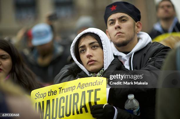 Luz M. Cortez and Berto Aguayo embrace during a protest demonstration near the National Mall before the inauguration of Donald Trump as the 45th...