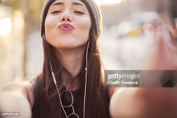 young beautiful spanish woman in the streets of barcelona. - selfie girl stockfoto's en -beelden