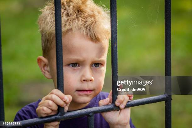 behind bars - child behind bars stock pictures, royalty-free photos & images